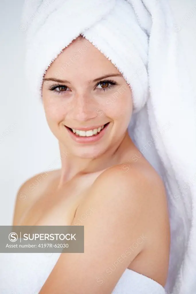 Portrait of an attractive young woman with a towel on her head