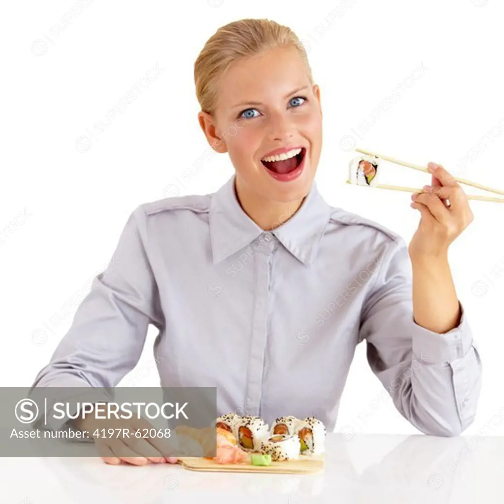 Portrait of a beautiful young woman eating portion of sushi