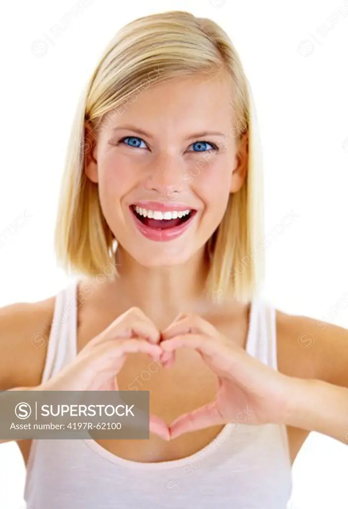 Studio portrait of an attractive young woman making a heart sign with her hands and smiling enthusiastically