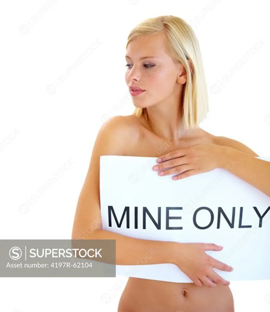Studio shot of a beautiful young woman covering herself with a sign reading 'MINE ONLY'