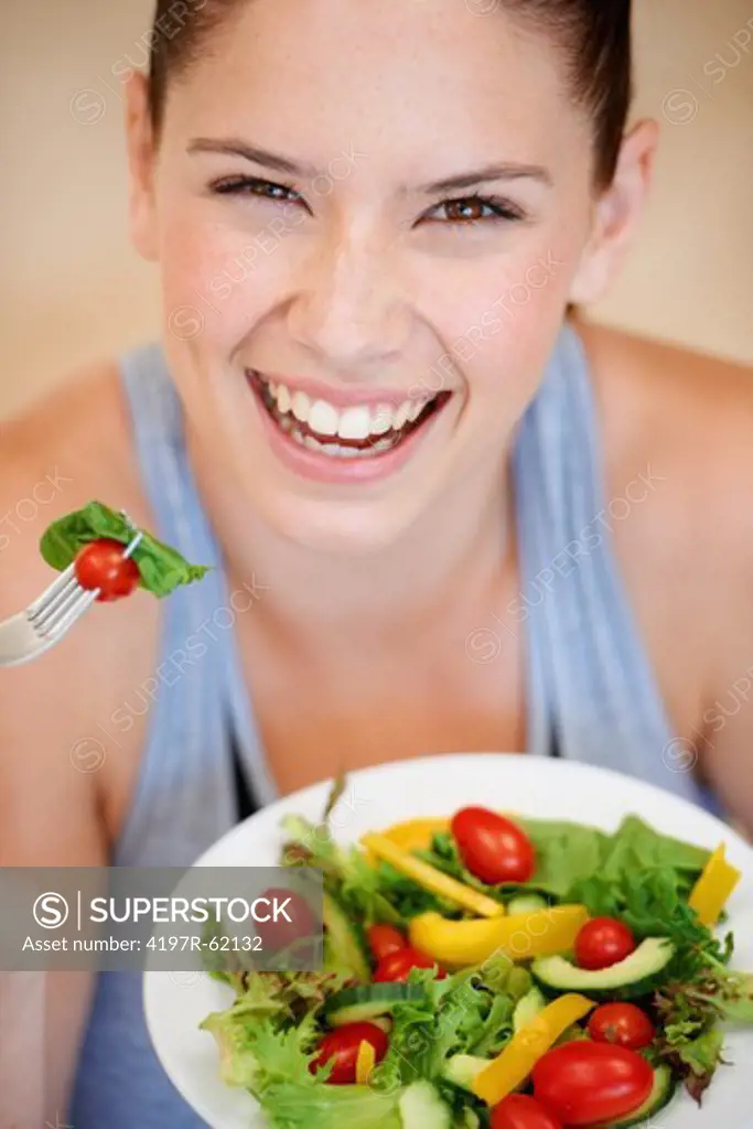 Healthy young woman enjoying a fresh green salad