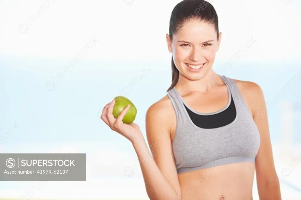 A beautiful young woman eating an apple