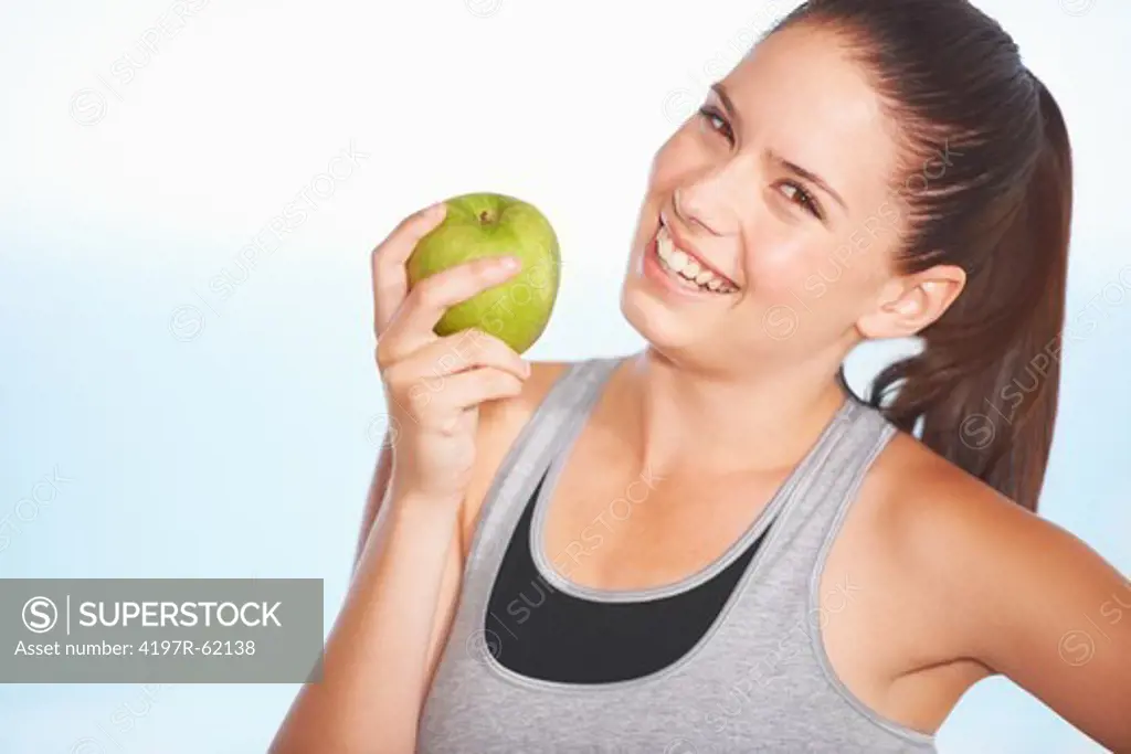 An attractive young woman eating an apple