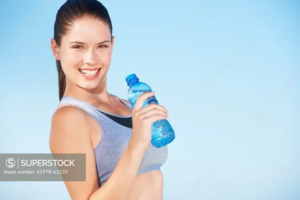 An attractive young woman holding a bottle of water