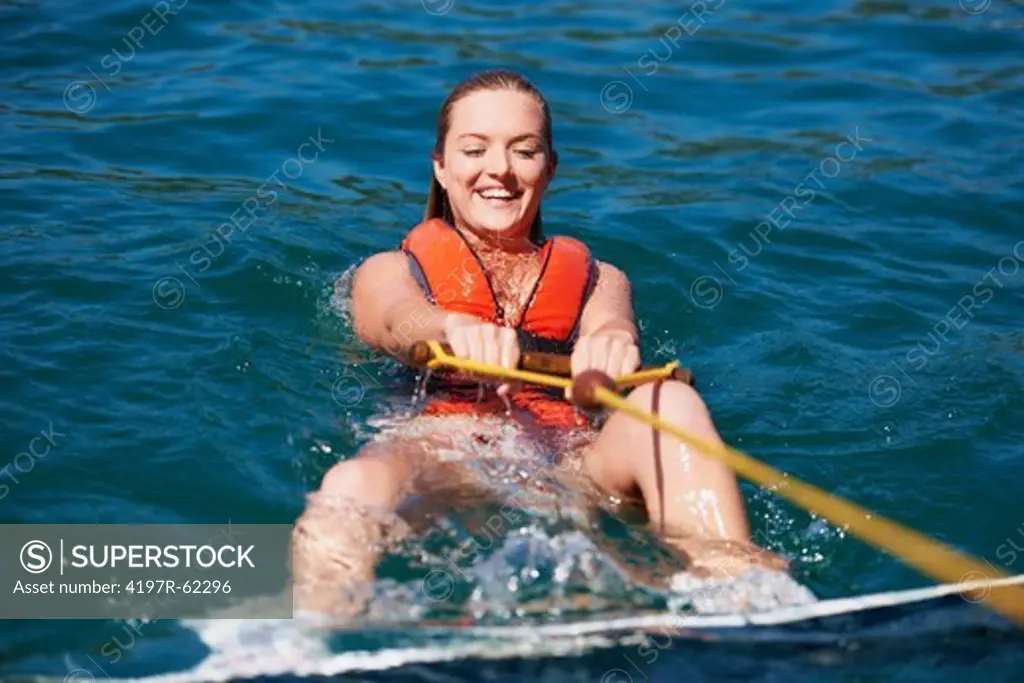 Portrait of a smiling female wakeboarder in the lake