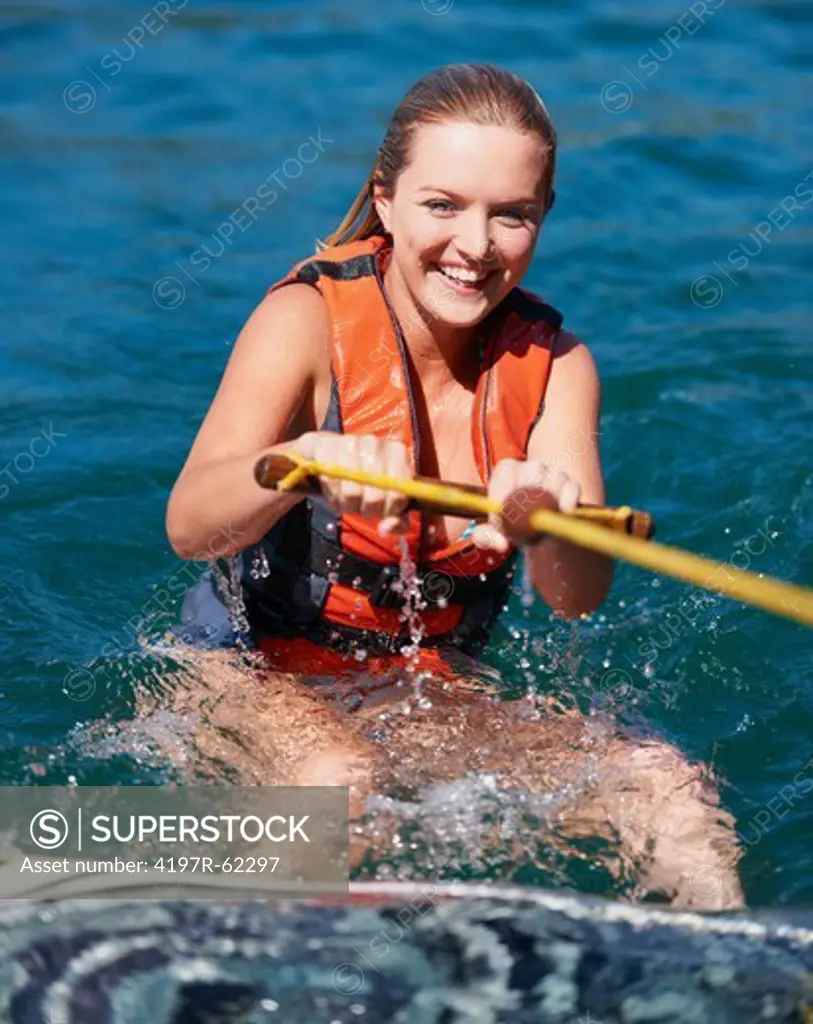 Portrait of a smiling female wakeboarder in the lake