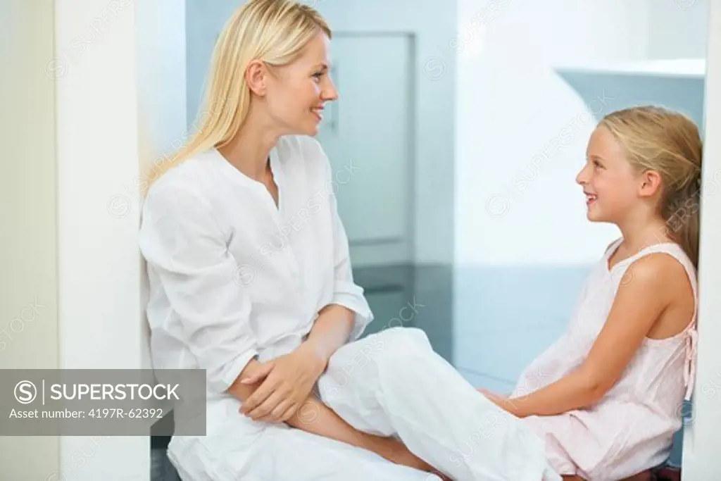 A mother and daughter sitting together and talking