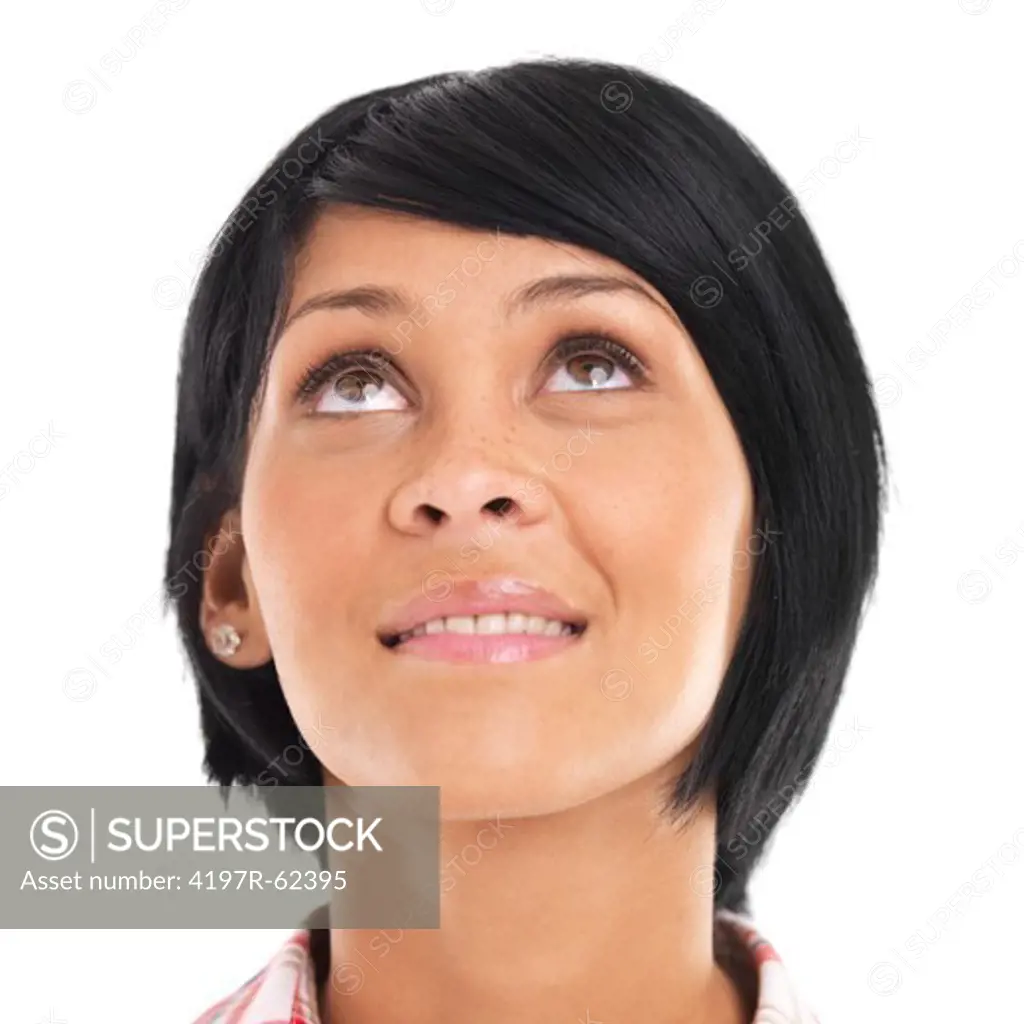 Casual young woman looking up with a smile against a white background