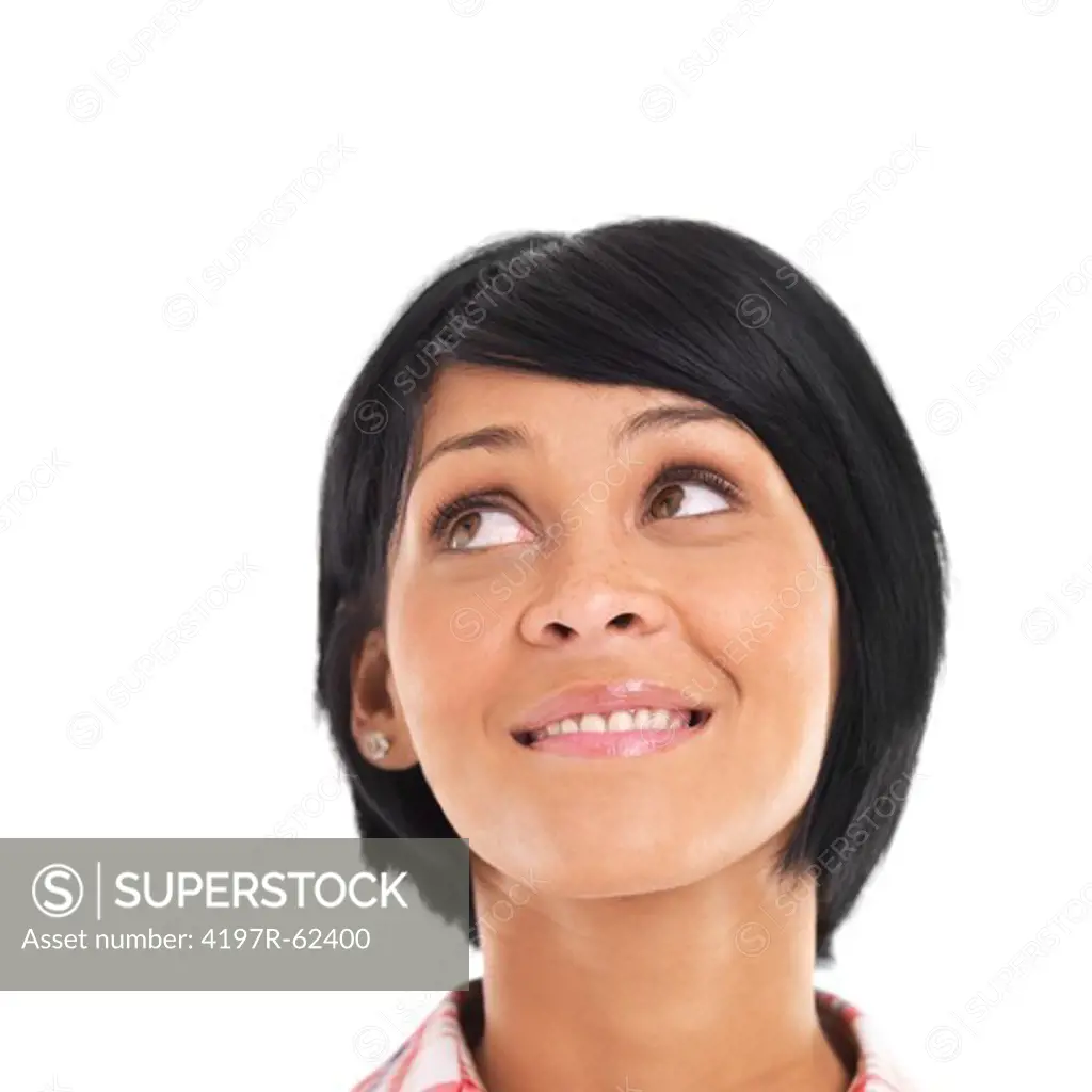 Casual young woman looking up with a smile against a white background