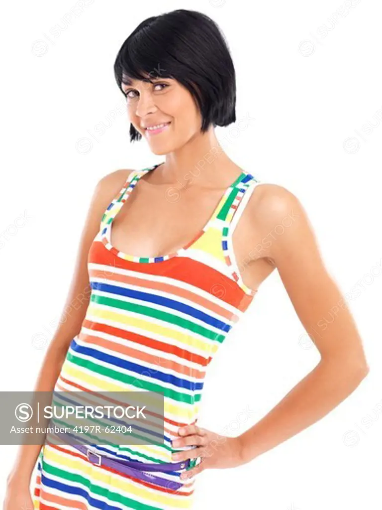 Casual young woman smiling while standing against a white background