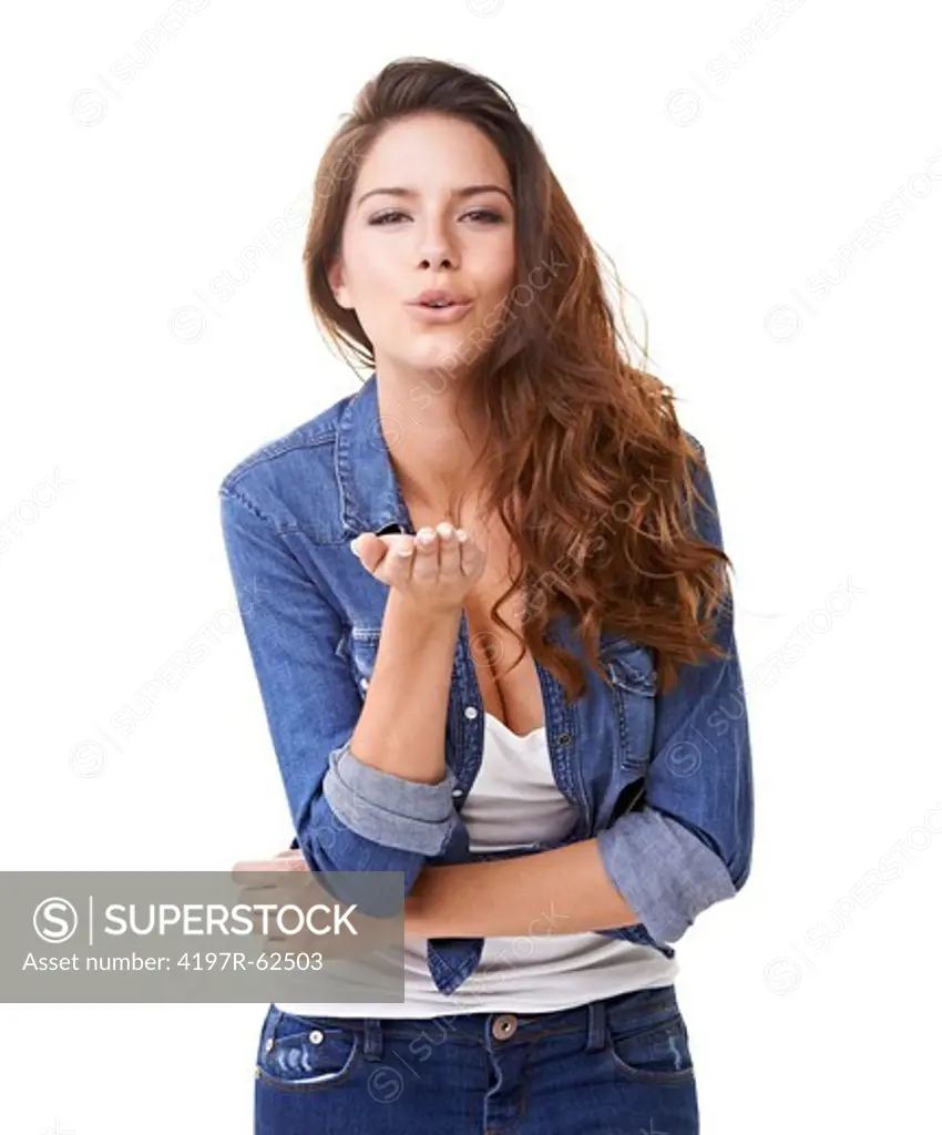 Studio portrait of a beautiful young woman blowing a kiss at the camera isolated on white