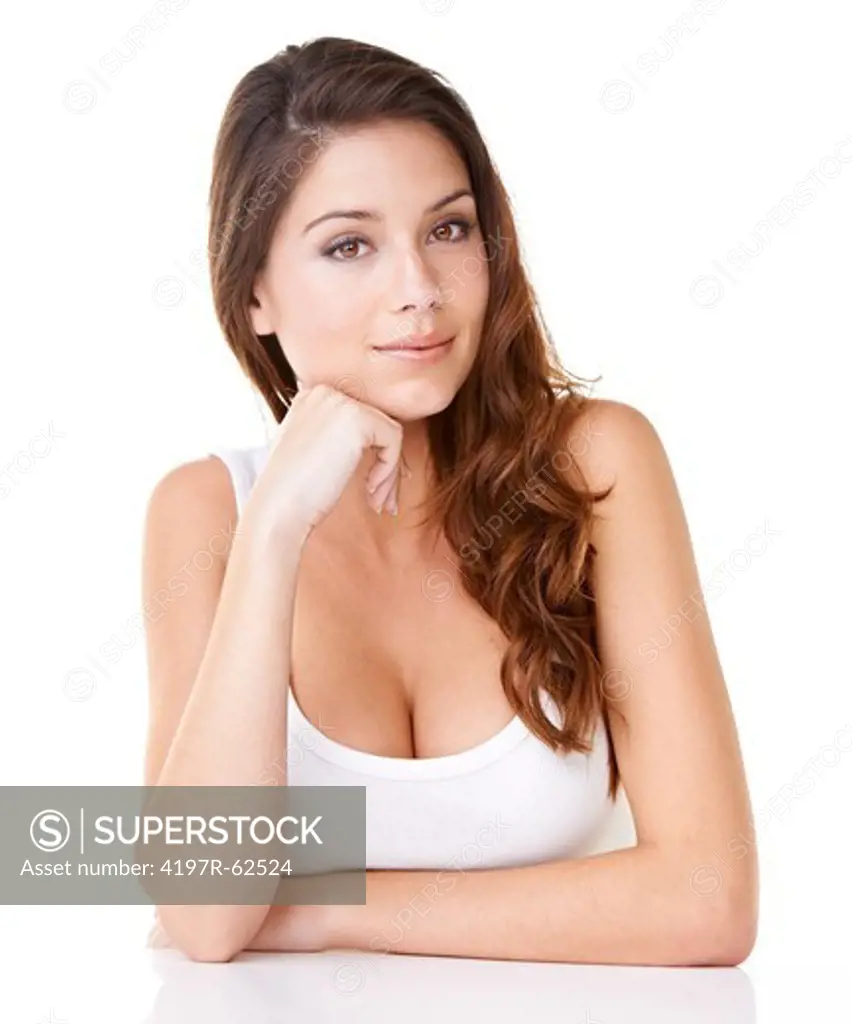 Studio portrait of an beautiful brunette woman with her hands on her chin isolated on white
