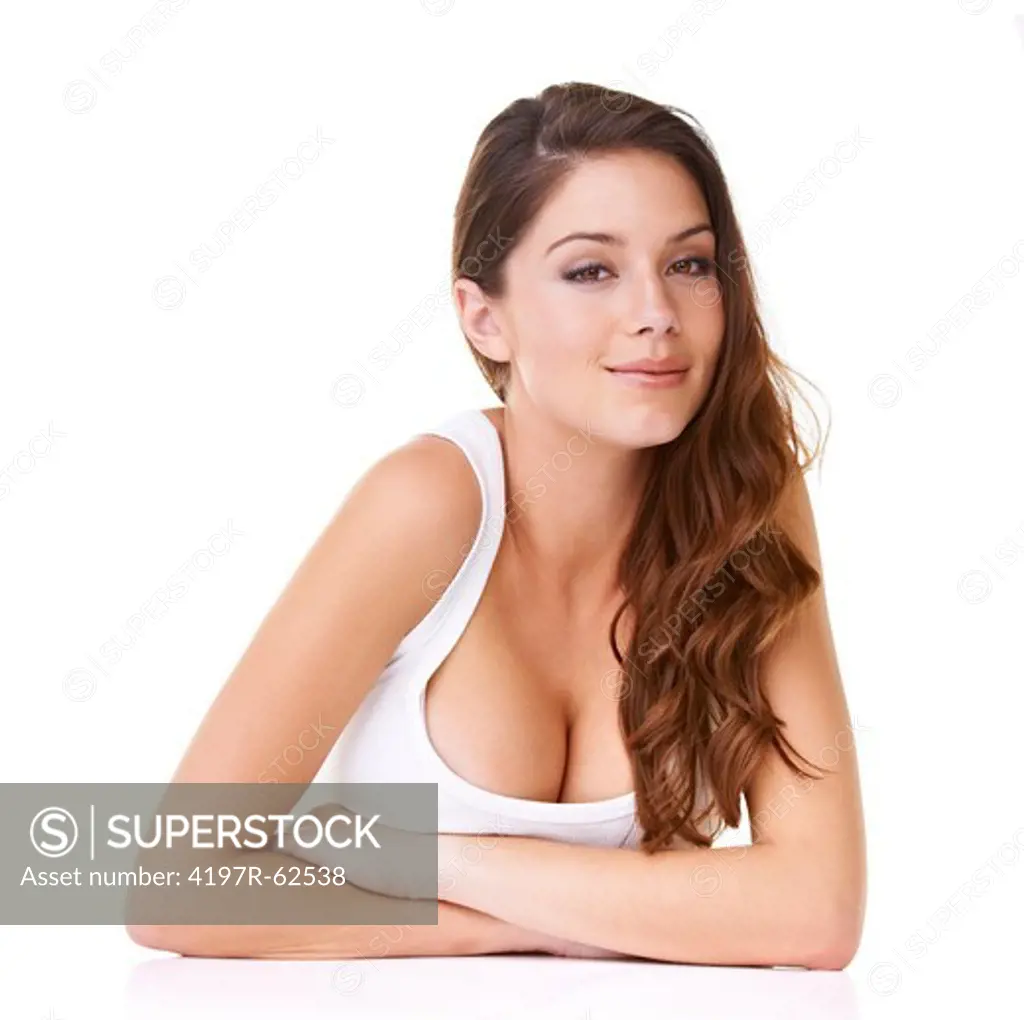 Studio portrait of a beautiful young brunette woman looking alluringly at the camera isolated on white