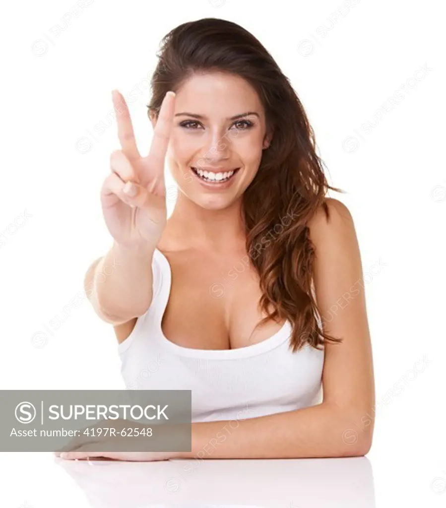 Shot of an attractive young woman giving the 'peace' to the camera isolated on white