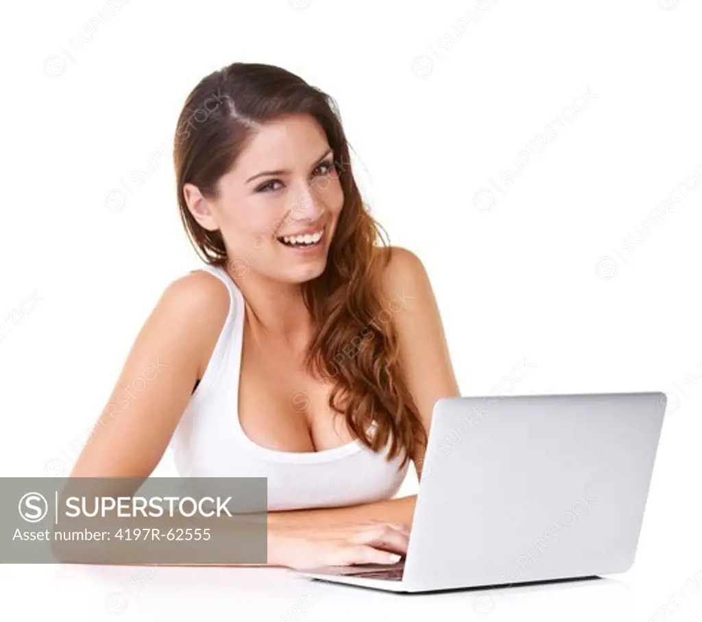 Shot of an attractive young woman working on a laptop and smiling at the camera