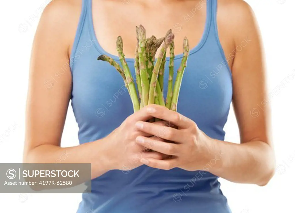 Cropped studio shot of a woman holding a asparagus spears isolated on white