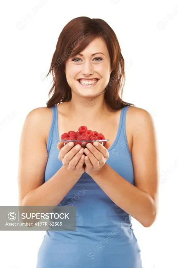 Studio portrait of an attractive young woman holding a bowl full of raspberries isolated on white