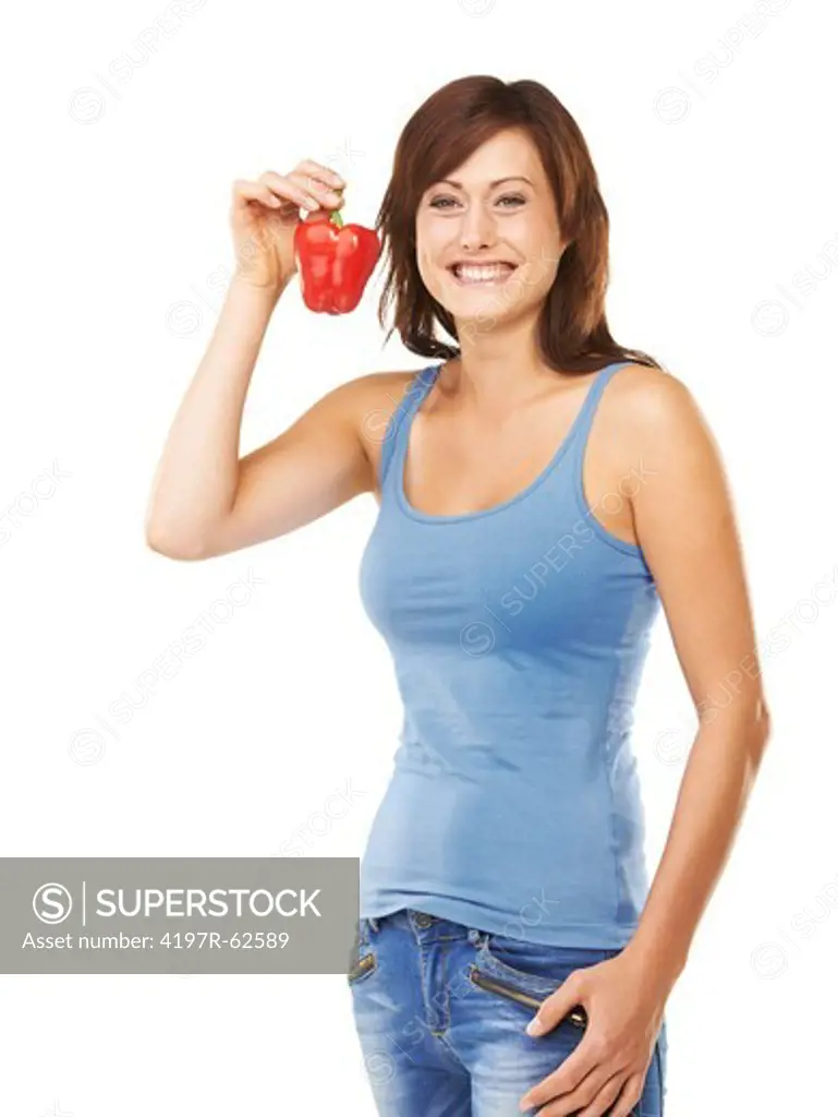 Studio portrait of an attractive young woman holding up a red capsicum in one hand isolated on white