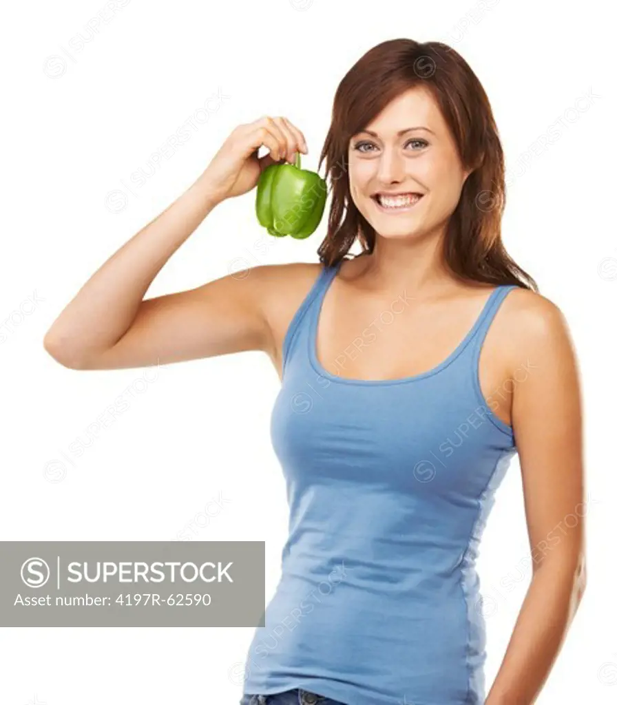 Studio portrait of an attractive young woman holding up a green capsicum in one hand isolated on white