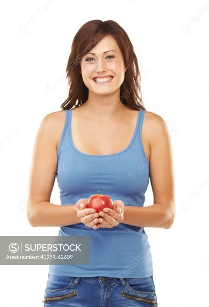 Studio portrait of a young woman holding an apple in front of her waist isolated on white