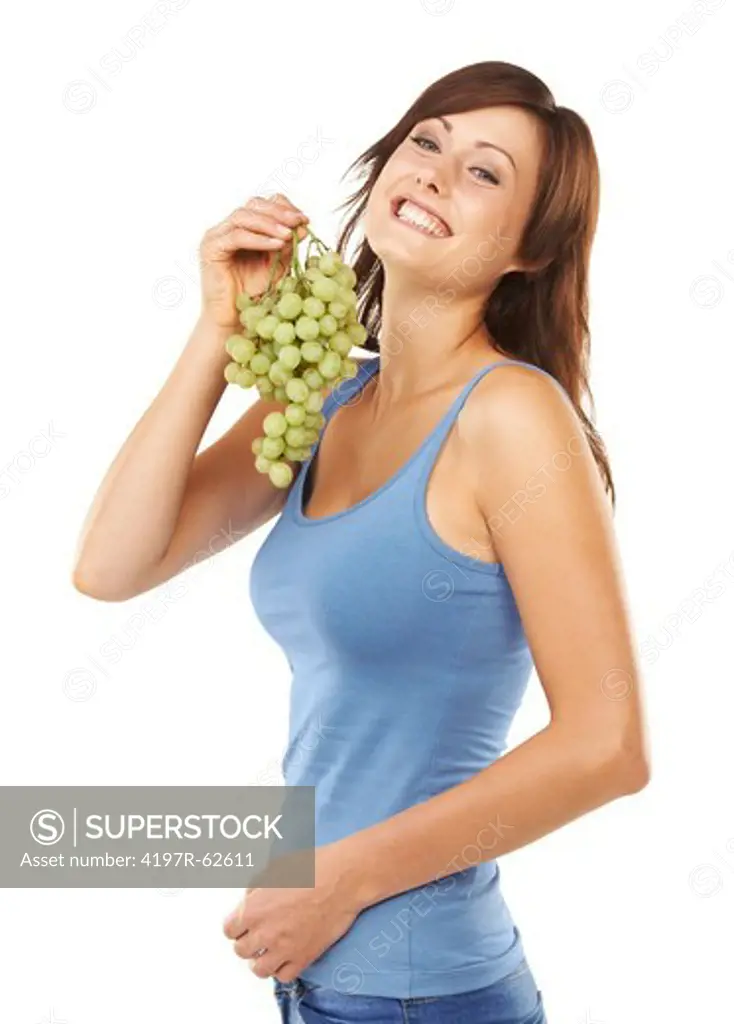Studio portrait of an attractive young woman holding a bunch of grapes isolated on white