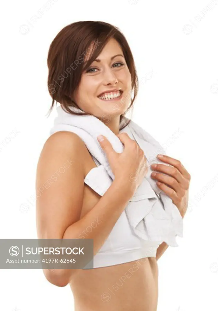 Sideways studio portrait of a sporty young woman standing with a towel around her neck isolated on white