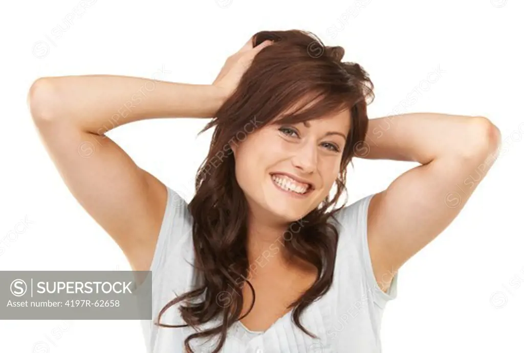Playful studio portrait of a young woman running both hands through her hair isolated on white