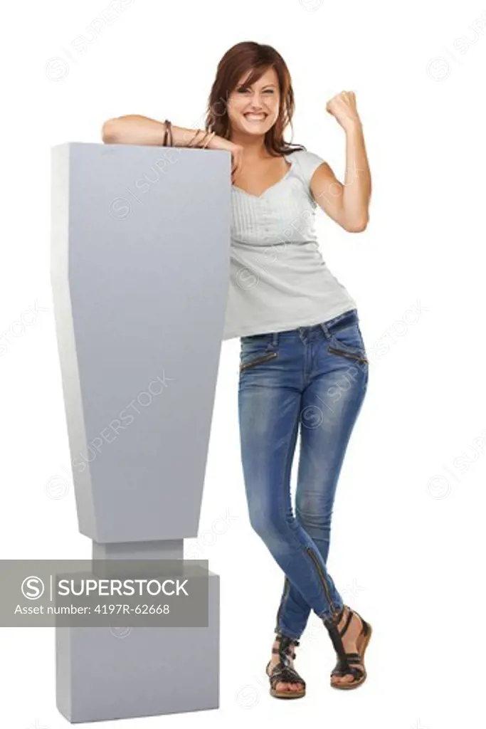 Full length studio concept shot of an enthusiastic-looking young woman standing next to a large exclamation mark isolated on white