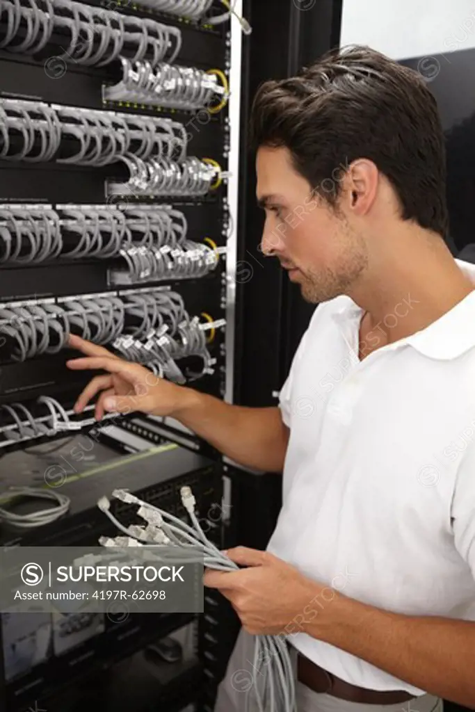 Young IT consultant working in a server room