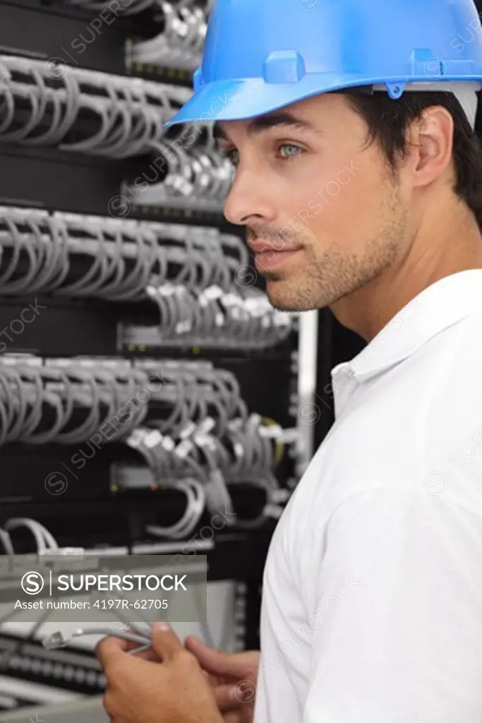 Professional young IT consultant working in a server room