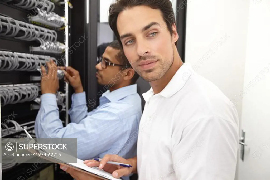 Well-trained young IT consultants working in a server room