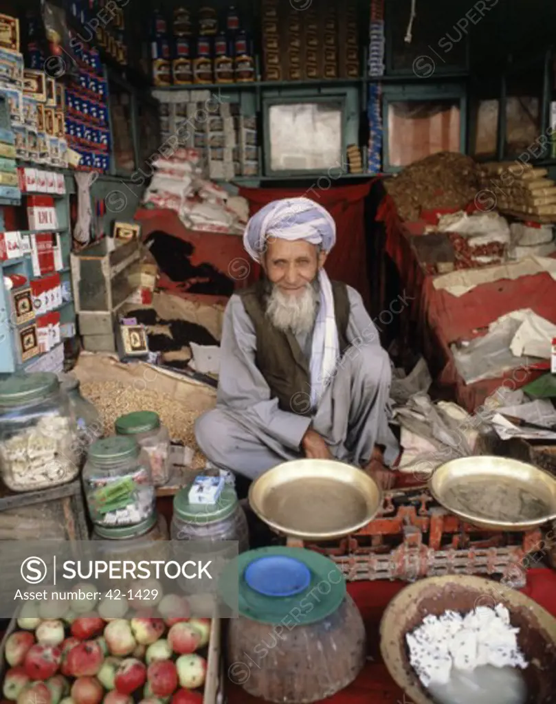 Portrait of a senior man sitting in his shop, Kabul, Afghanistan