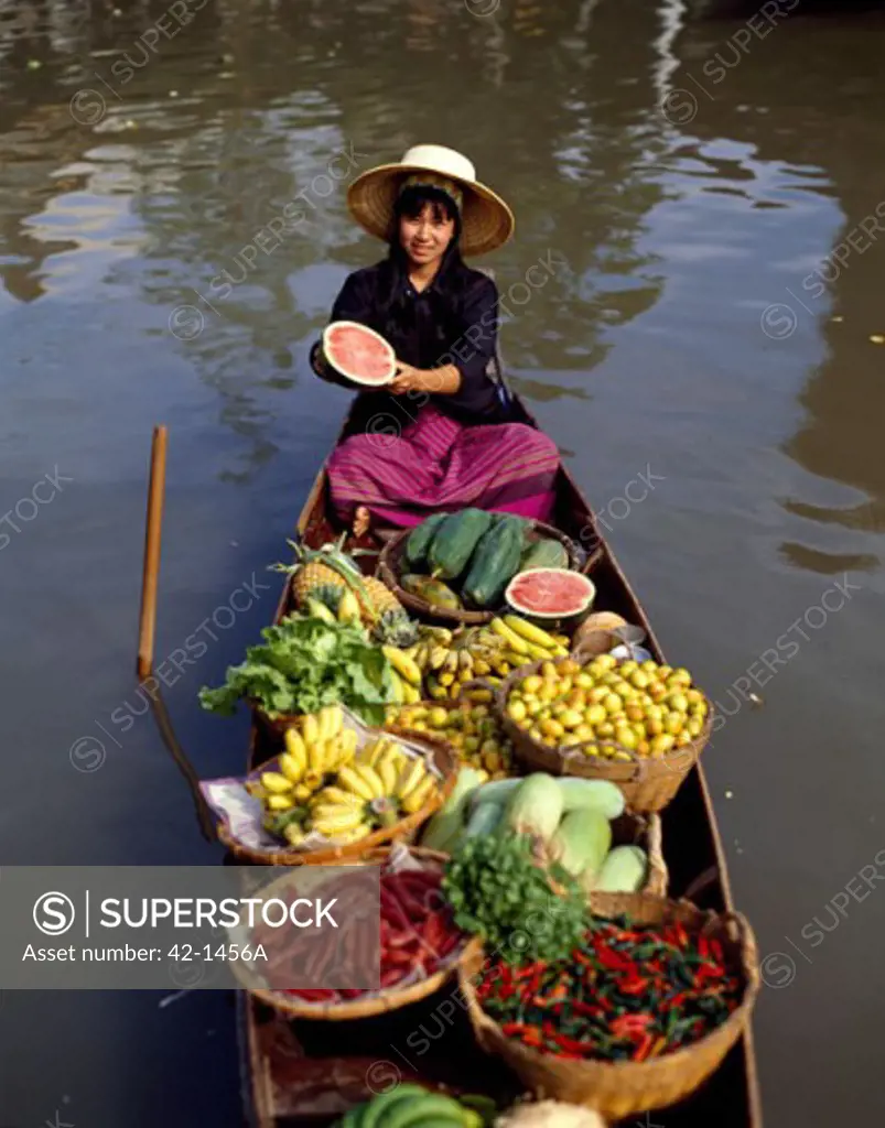 High angle view of a market vendor selling fruit in a boat, Damnoen Saduak, Floating Market, Bangkok, Thailand
