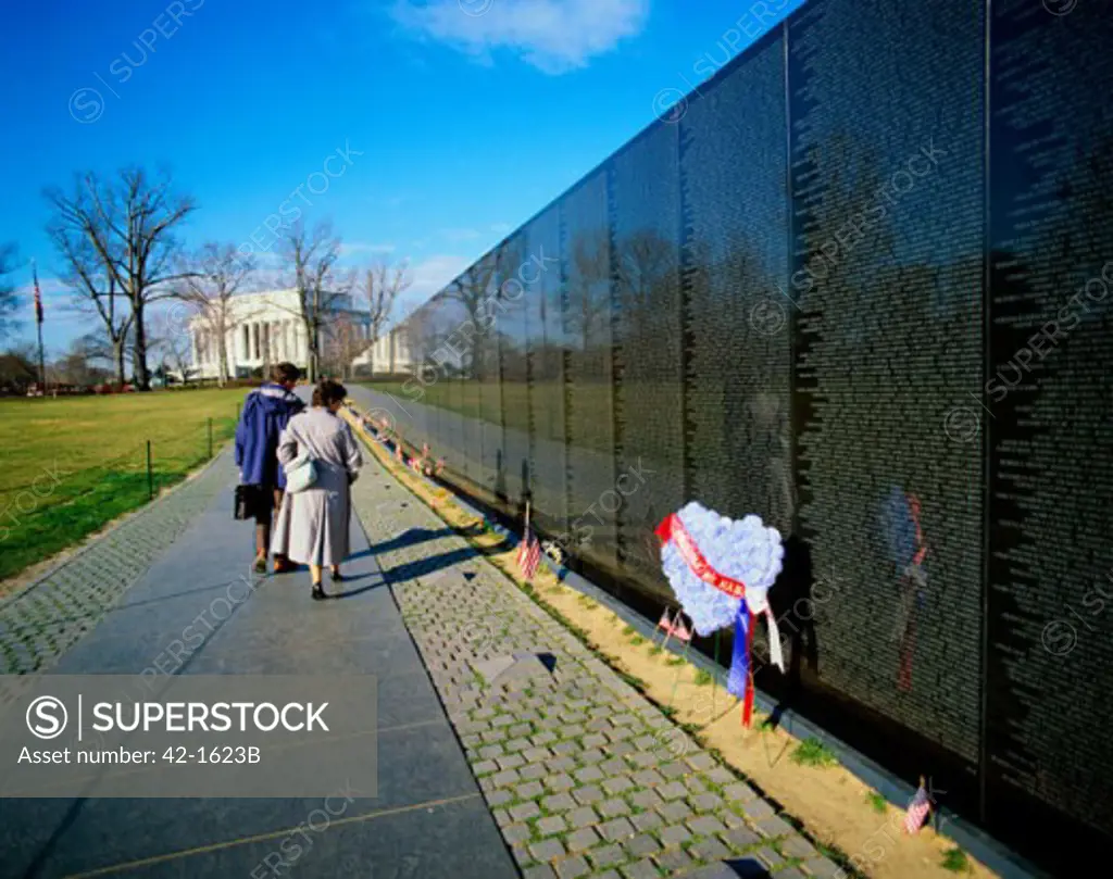 Rear view of two people at a memorial, Vietnam Veterans Memorial Wall, Vietnam Veterans Memorial, Washington DC, USA