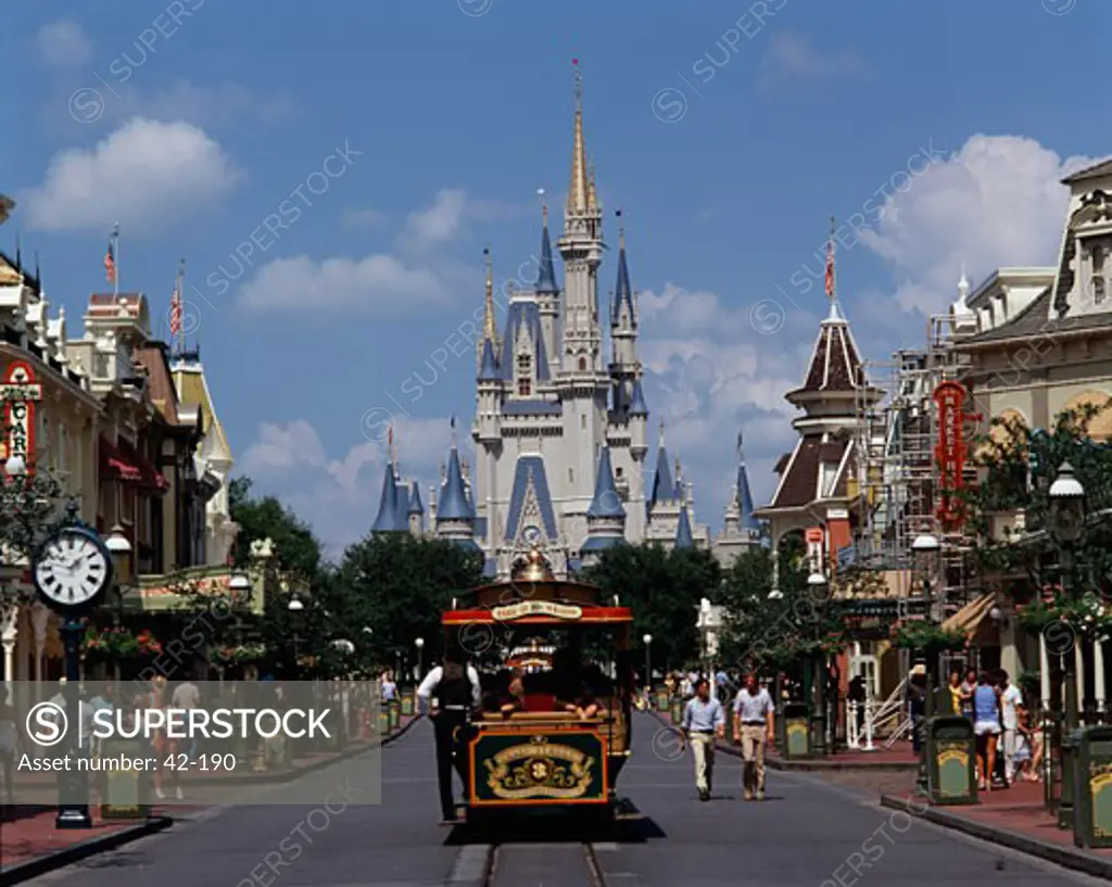 Tourists walking on a street, Cinderella Castle, Magic Kingdom, Walt Disney World, Orlando, Florida, USA