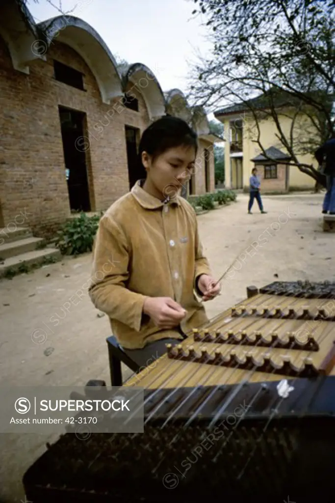 Young woman playing a yangqin, Kwangsi Arts Institute, Nanning, China
