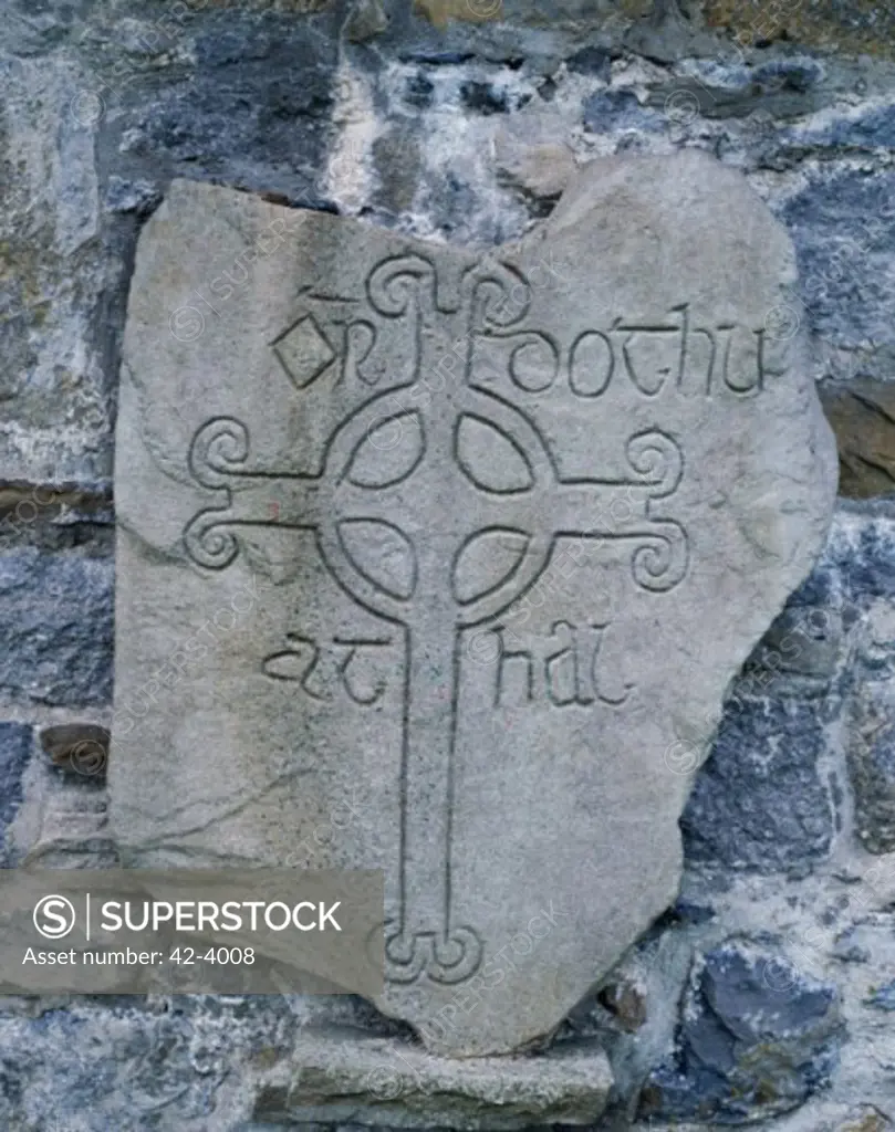 Celtic cross engraved on a rock, Clonmacnoise, Ireland