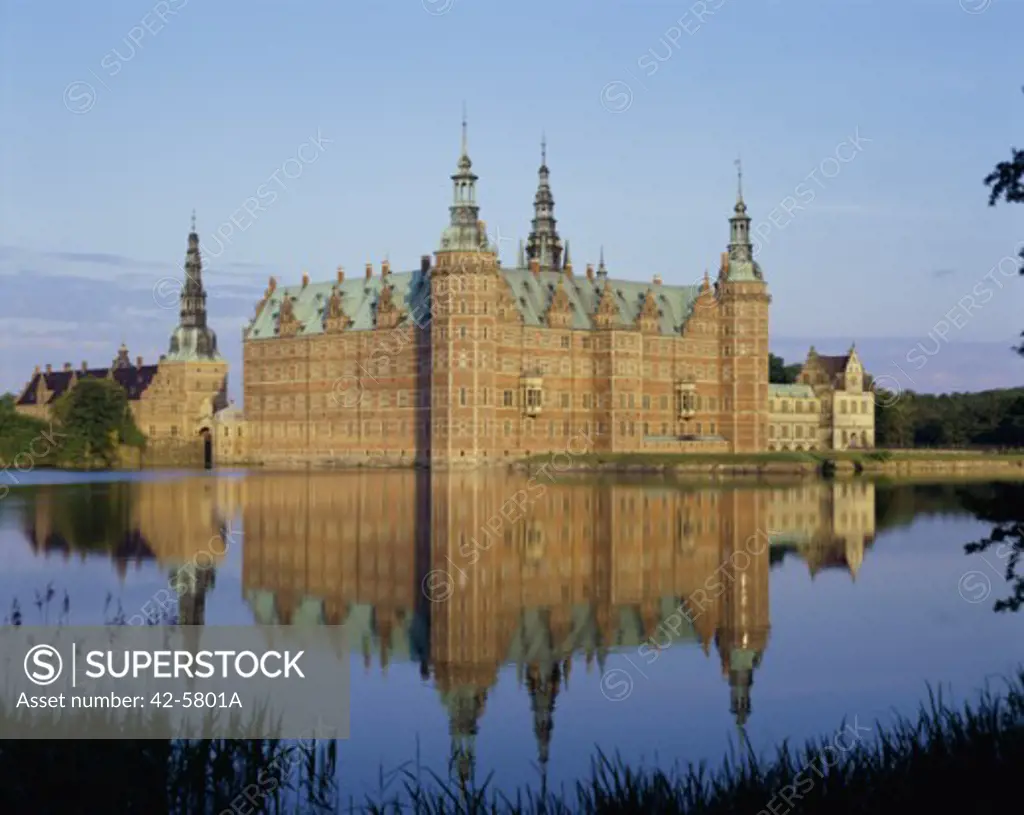 Reflection of a castle in water, Frederiksborg Castle, Hillerod, Denmark