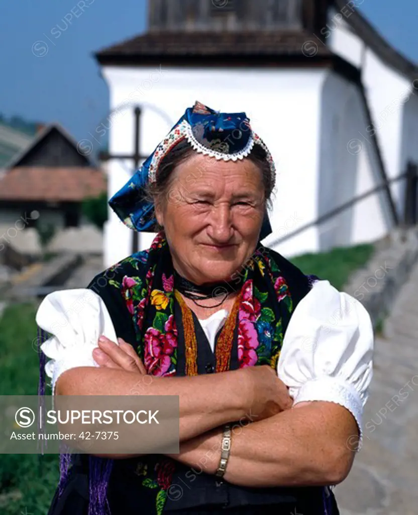 Portrait of a senior woman standing with her arms crossed, Holloko, Hungary