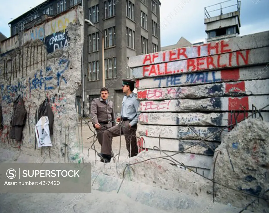 Two men standing near a wall, Berlin Wall, Berlin, Germany