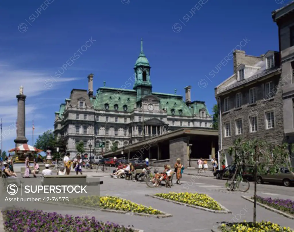 Tourists sitting in front of buildings, Place Jacques Cartier, Town Hall, Montreal, Canada