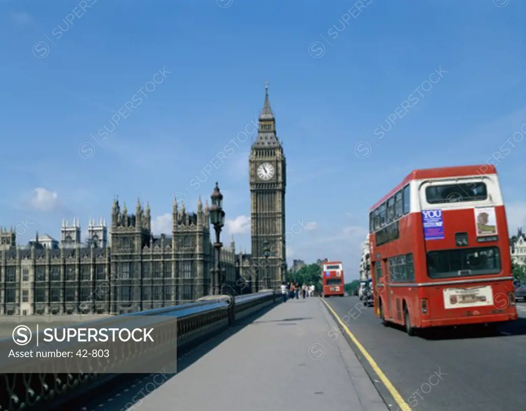 Double-decker bus moving on a bridge, Big Ben, Houses of Parliament, London, England