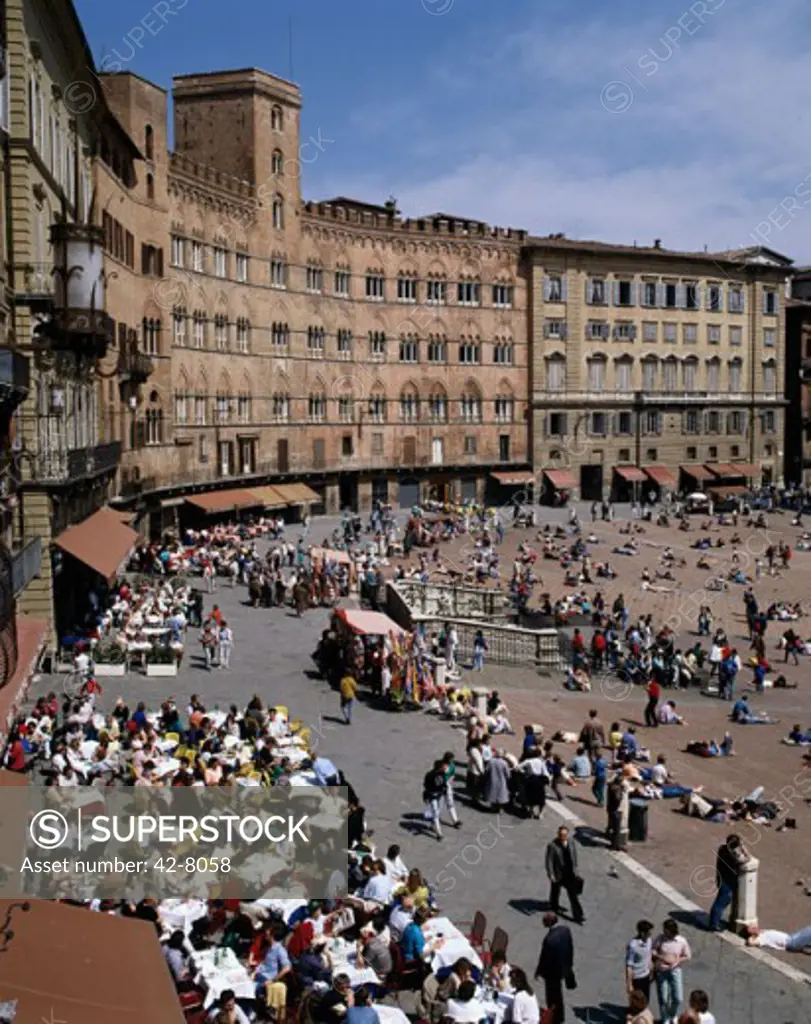 High angle view of tourists sitting at a sidewalk cafe, Piazza del Campo, Siena, Italy