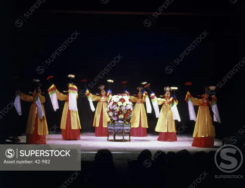 Group of young women dressed in traditional costumes and dancing on a stage, South Korea