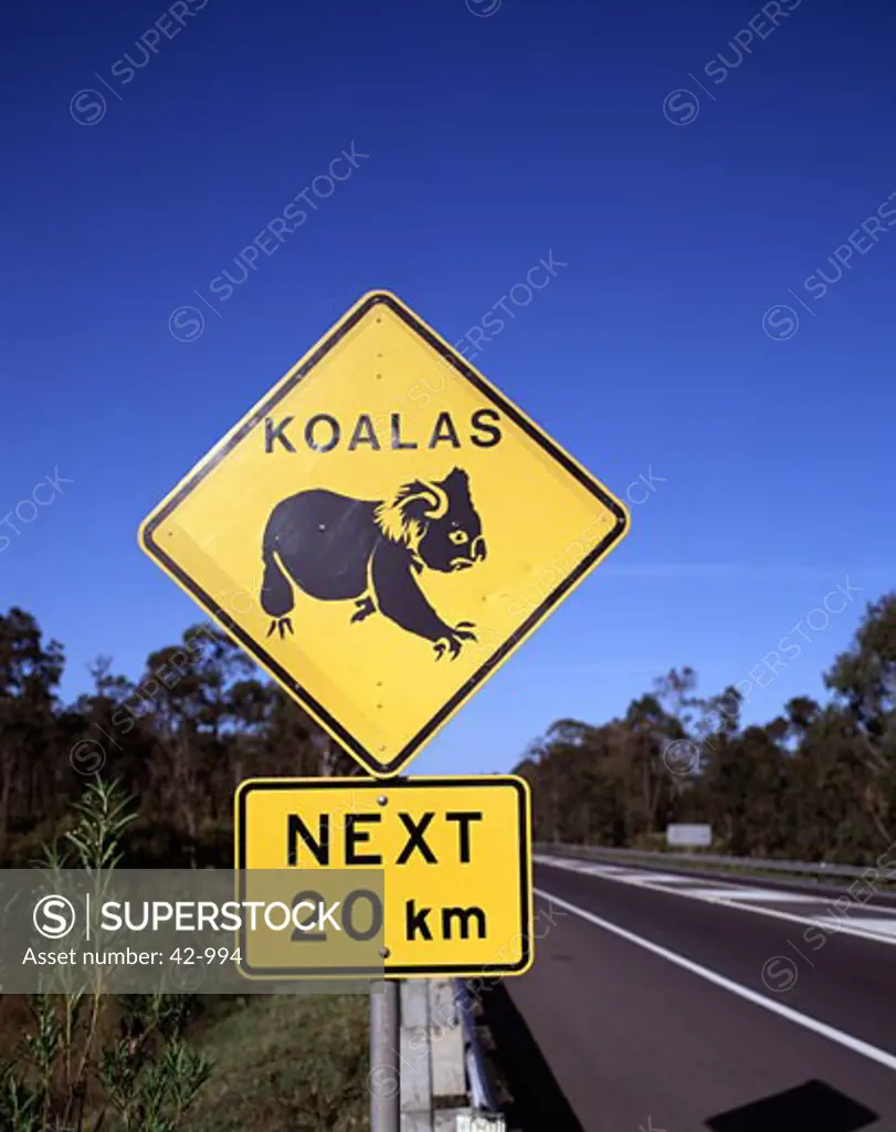 Close-up of a crossing sign on the road side, Australia