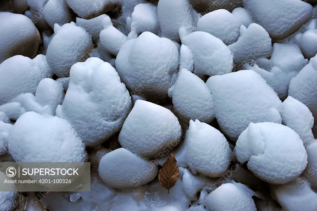 Snow-covered stones embedded in ice, Switzerland