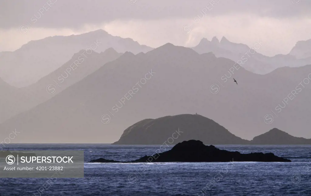 Islands and mountain ranges silhouetted around Cumberland East Bay, South Georgia