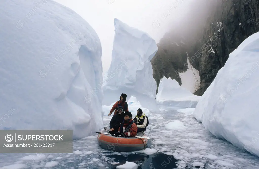 People in inflatable boat in icy seas, Trinity Island, Antarctica