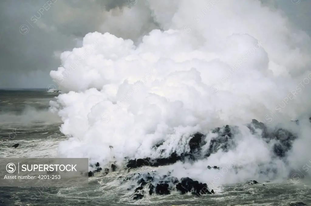 An Aa lava flow entering the sea causing steam plume and roil, Cape Hammond, Fernandina Island, Galapagos Islands, Ecuador