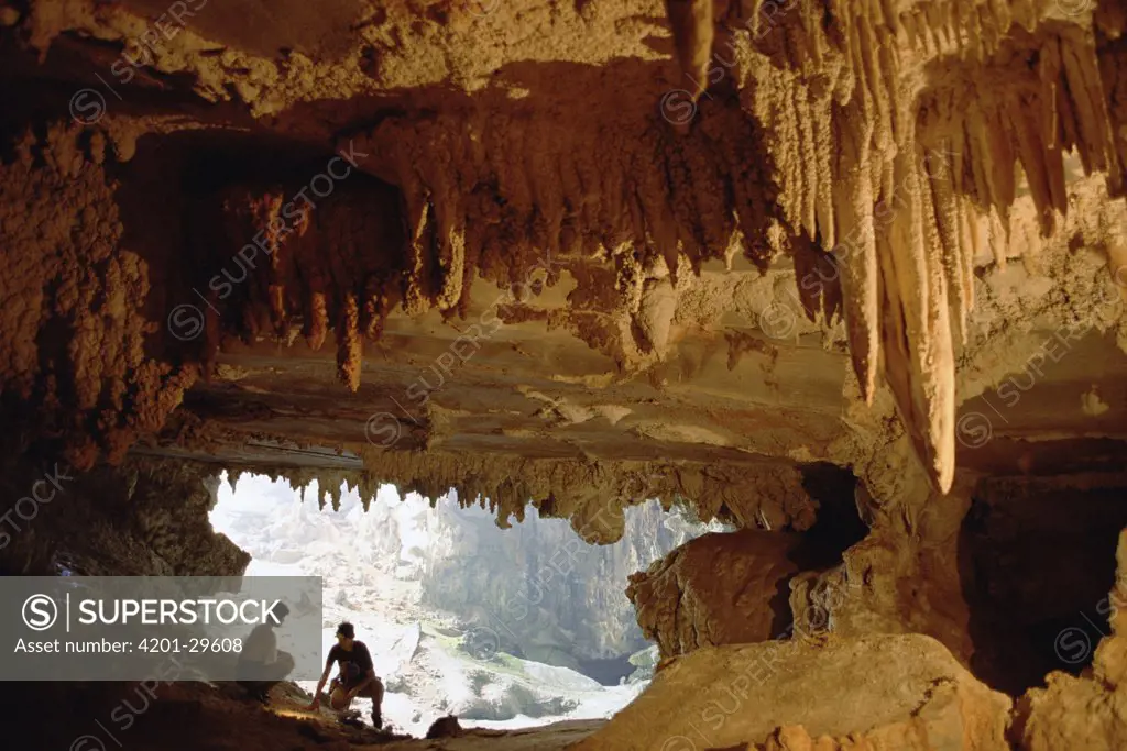 Visitors explore an expansive cavern with stalactites, Vale Do Peruacu, Minas Gerais, south Cerrado savannah, Brazil
